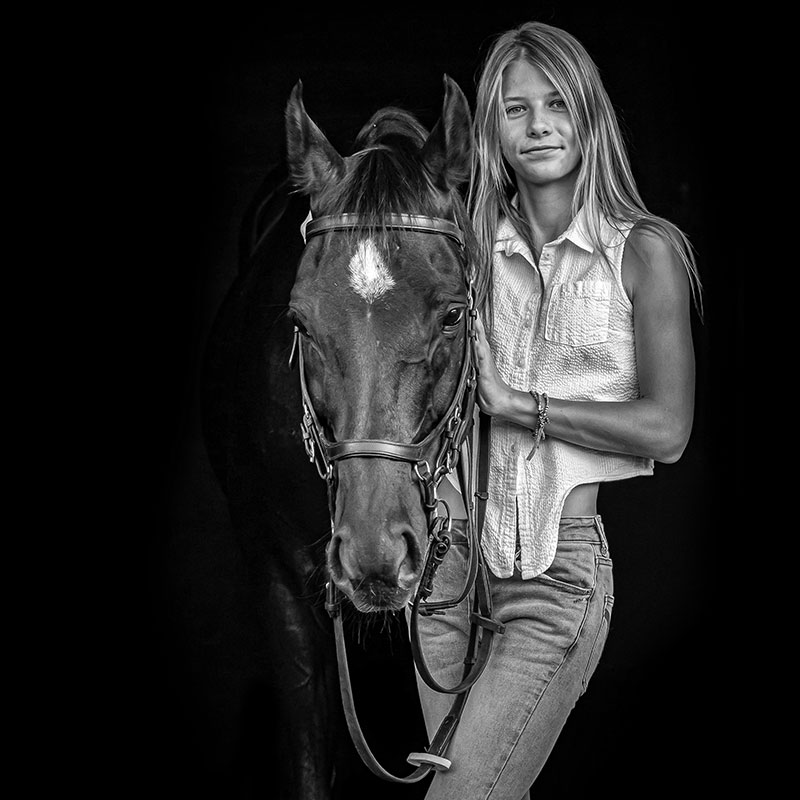Girl and horse fine art black and white black background portrait photo